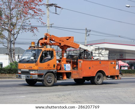 CHIANGMAI , THAILAND -FEBRUARY  9 2015:  Bucket truck of  Provincial eletricity Authority of Thailands. Photo at road no.1001 about 8 km from downtown Chiangmai, thailand.