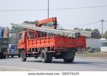 CHIANGMAI , THAILAND- FEBRUARY 5 2015:  Private Truck with crane for transportation of electricity post. Photo at road no 121 about 8 km from downtown Chiangmai, thailand.