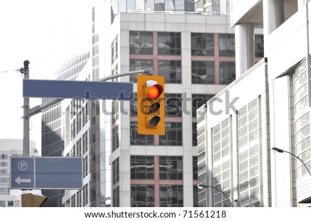 Traffic light on busy downtown intersection.
