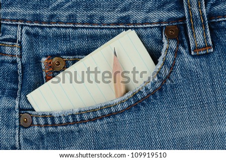 Blue jeans pocket with paper and pencil in the pocket.