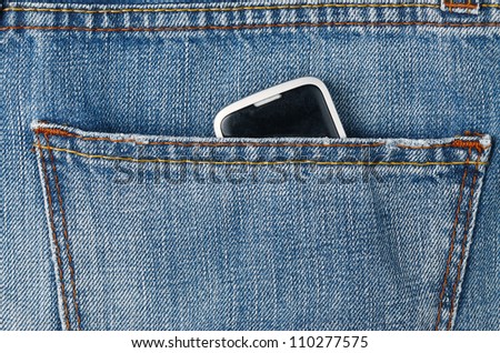Mobile phone in blue jeans pocket.