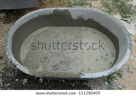 Wet cement mix in basket.