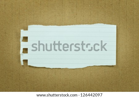 Blank torn paper on brown paper background.