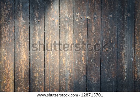 Grunge wood wall panel with light.