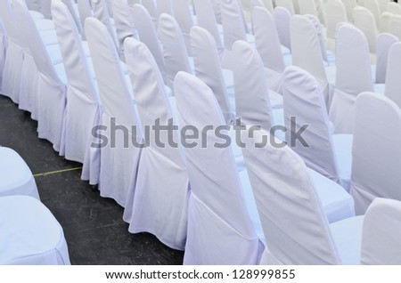 Chairs in row cover with white.