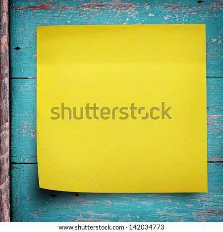 Yellow sticker paper note on wood wall
