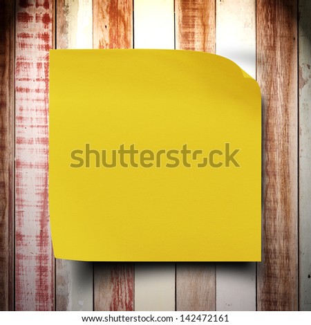 Grunge vintage wood wall with yellow sticker paper note