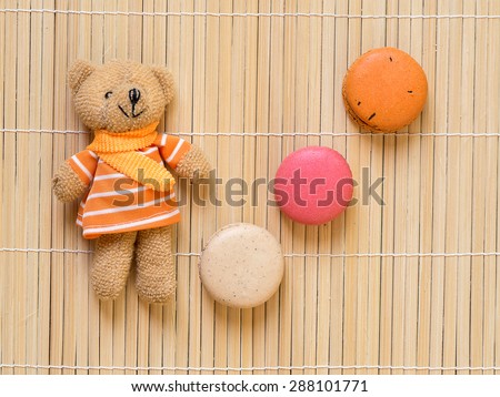 Macaroons top view with cute doll