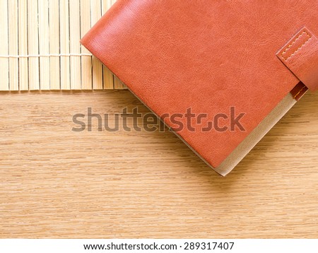 Note book on bamboo and wood table background
