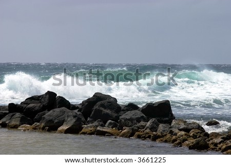 Crashing ocean surf and rocky reef.