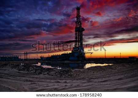 Oil rig on dramatic sunset background - high dynamic range image