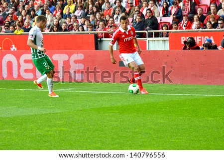 LISBON, PORTUGAL - MAY 19: Sport Lisboa e Benfica team VS Moreirense team in the last game for National league .Lima try to pass the ball to his fellows.  Lisbon - Portugal, 19 May 2013