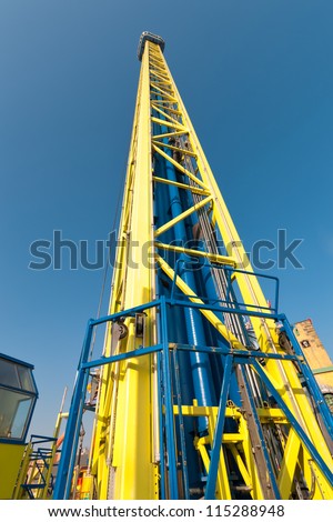 Free fall tower in amusement park against blue sky