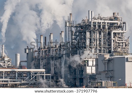 detail of smoking chimneys of a petrochemical factory in an oil refinery