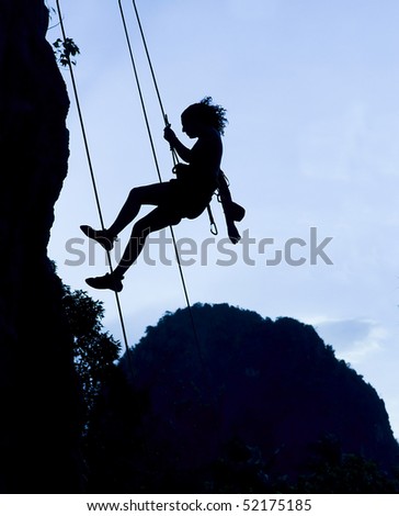Silhouette of climbing woman in Railey, Thailand