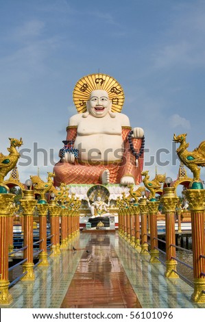 Fat laughing Buddha over blue sky, Koh Samui. Thailand