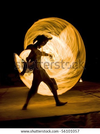 Young man on fire performance. Motion blurred