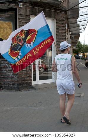 WARSAW, POLAND - JUNE 16: Russian fan with flag at Warsaw street  before UEFA EURO 2012 Russia vs. Greece football match, June 16, 2012 in Warsaw, Poland