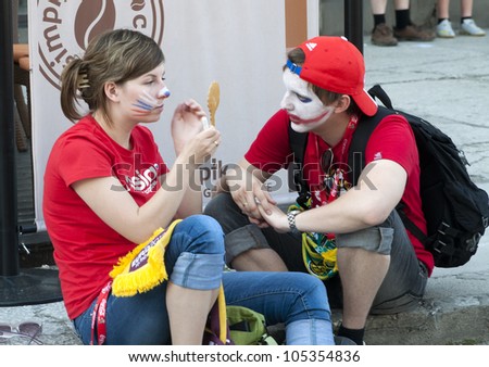WARSAW, POLAND - JUNE 16: Russian fans make face painting before football match with Greece on July 16, 2012 in Warsaw, Poland. Uefa Euro 2012 is hosted by Poland and Ukraine.