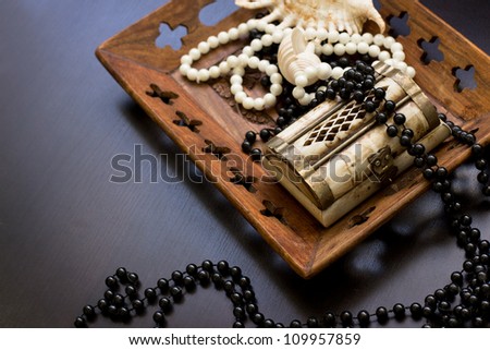 Jewels in a nacreous shell on a dressing table/Still life with wooden treasure chest with pearl necklaces./ pearl necklace and seashell over stones