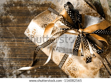 Vintage holidays gifts with packaging paper and atlas bows/vintage selebration background with grunge texsture/christmas background