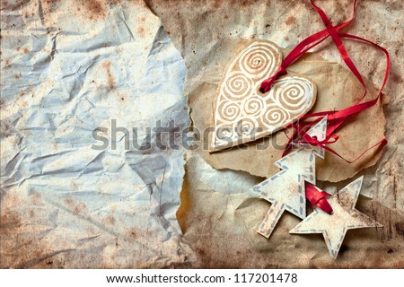 christmas heart with star and tree on vintage paper background/vintage christmas card  with retro paper decorations