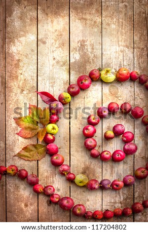 Vintage Autumn border from apples and fallen leaves on old wooden table/Thanksgiving day concept/background with apples