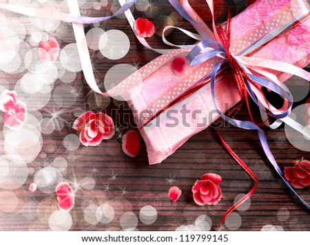 Holidays background/ Holidays present with bow from atlas ribbon/ Romantic holidays gift