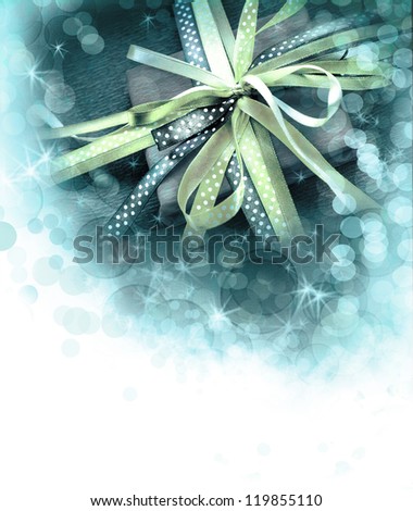 Christmas background/ Holidays present with bow from atlas ribbon/ Romantic holidays gift
