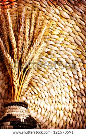 still life with and ears of wheat/composition with natural  ears of rye on a vintage on vine woven  basket background/