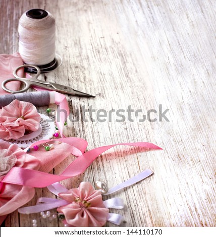 Scrapbooking craft materials/Background with sewing tools and colored tape/Sewing kit. Scissors, bobbins with thread and needles on the old  wooden background