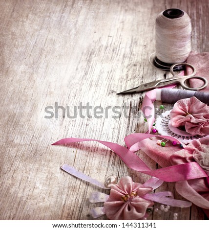 Scrapbooking craft materials/Background with sewing tools and colored tape/Sewing kit. Scissors, bobbins with thread and needles on the old  wooden background