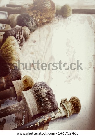 Set of old brush for coloring the walls/  Brush painting wooden furniture, close up/Paintbrush on wood background