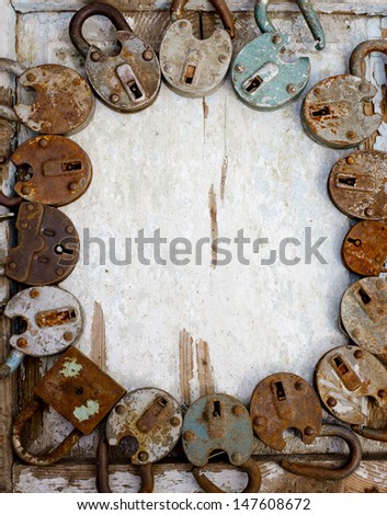 vintage background with locks and lots of keys on wooden table with grunge texture