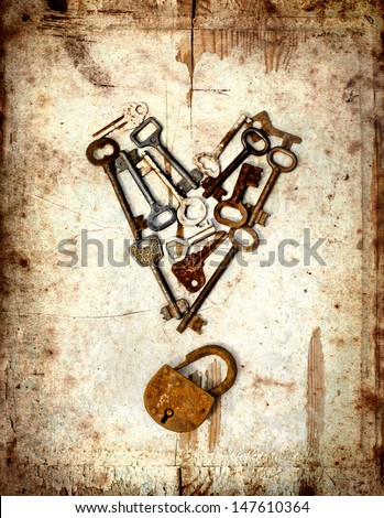 vintage background with locks and lots of  keys on wooden table with grunge texture/Heart from keys