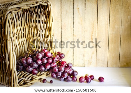 assortment of ripe sweet grapes in basket on wooden background/Grapes in the basket/ Summer Wine Season