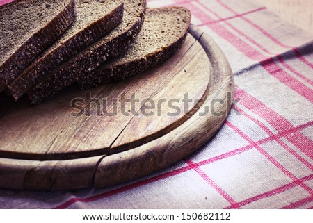 Sliced Monastery rye bread/ sliced ??brown bread on a wooden board