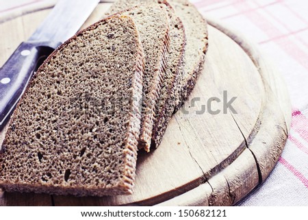 Sliced Monastery rye bread/ sliced ??brown bread on a wooden board