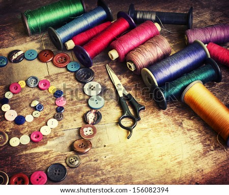 Vintage Background With Sewing/Sewing Kit. Scissors, Bobbins With Thread And Needles On The Old Wooden Background