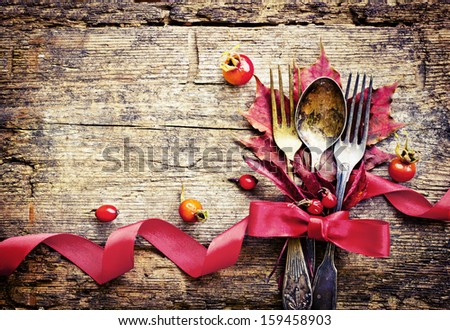 Thanksgiving table setting/ cutlery on the autumn background with  autumn leaves,ribbon on wooden abckground/Thanksgiving holidays background concept