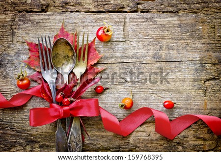 Thanksgiving Table Setting/ Cutlery On The Autumn Background With Autumn Leaves,Ribbon On Wooden Background/Thanksgiving Holidays Background Concept