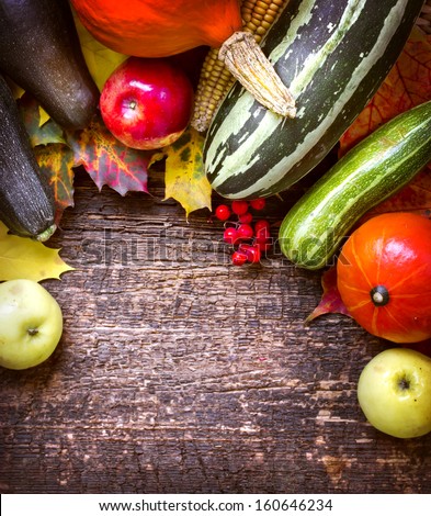 Healthy Organic Vegetables on a Wooden Background. Frame Design/Fruits and vegetables with pumpkins in autumn vintage still life
