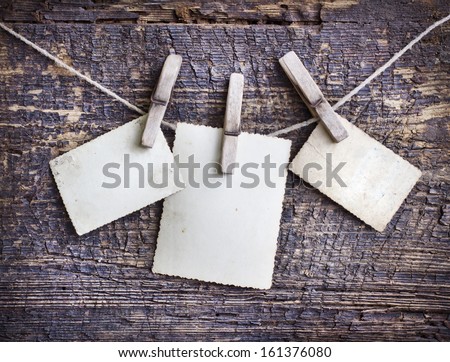 Photo Paper Attach To Rope With Clothes Pins On Wooden Background