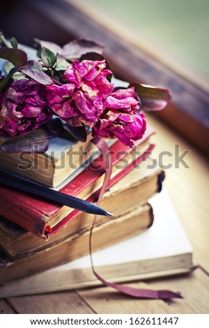 Dry rose on an old book/ Vintage Books and Roses