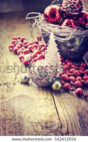 Vintage Christmas Ornament Background/ Christmas decorations in old pot on textured wooden background/  Composition with Brilliant Christmas Balls
