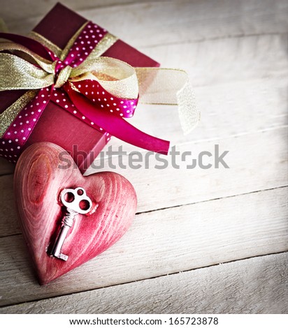 Valentines Day gift box and heart with key as a symbol of love. Vintage holiday background.