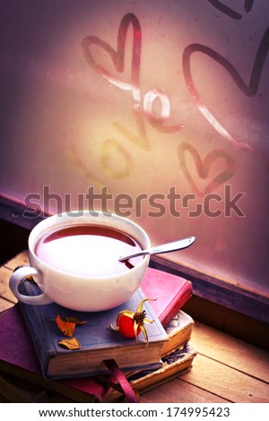 Romantic Vintage Background With Books And Tea/Cup Of Tea With Hip Roses On Wooden Table/ Valentines Day Background