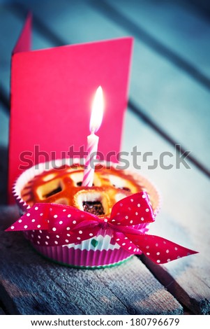 Holidays background with  Sweet Cupcake with candle