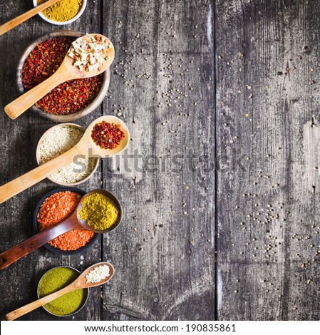 Colorful Spices and herbs over rustic wooden background
