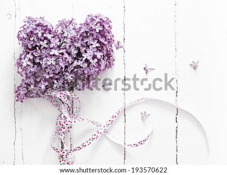 Bouquet of  lilac spring flowers on light shabby chic background
